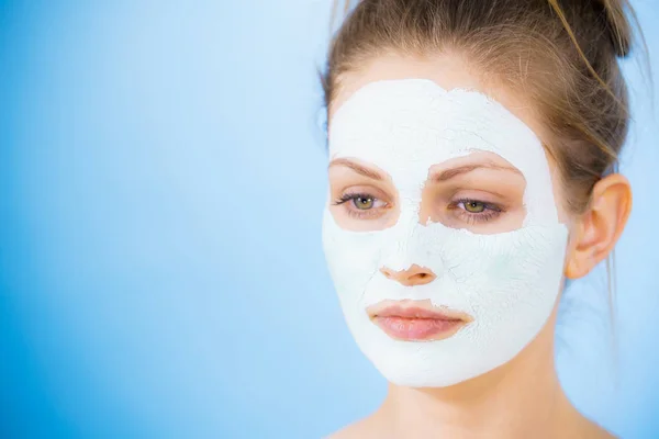 Girl with dry white mud mask on face