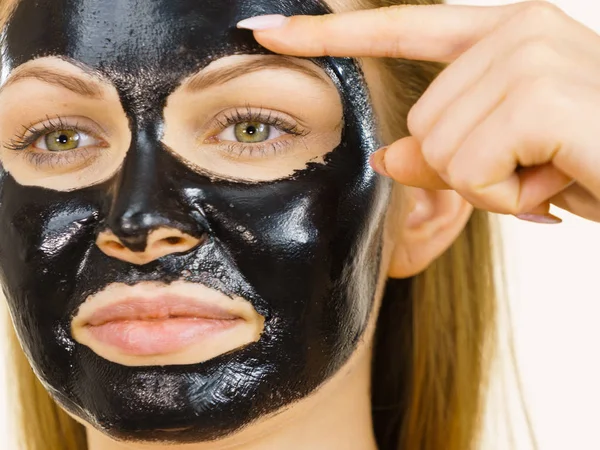 Girl black carbo peel off mask on face — Stock Photo, Image