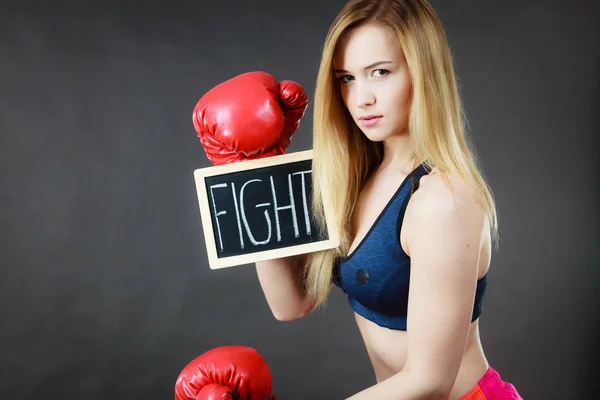 Woman wearing boxing glove holding fight sign — Stock Photo, Image