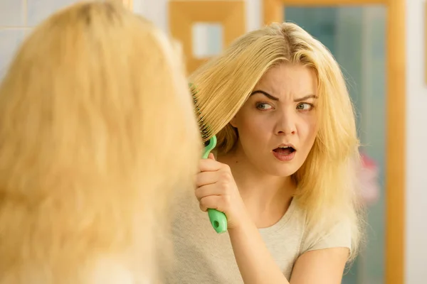 Sad woman brushing hair — Stock Photo, Image