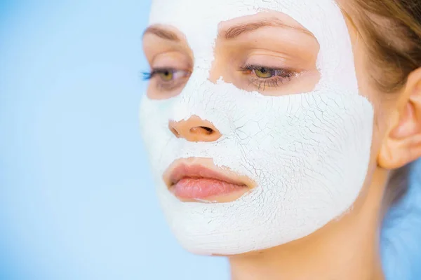 Girl with dry white mud mask on face