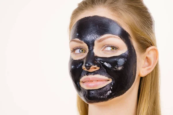 Girl black carbo peel off mask on face — Stock Photo, Image