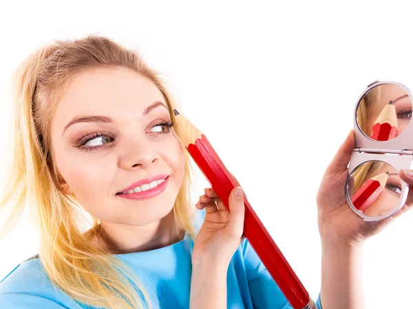Woman painting eyebrows using regular pencil Stock Picture