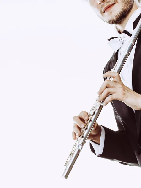 Male flutist wearing tailcoat holds flute — Stock Photo, Image