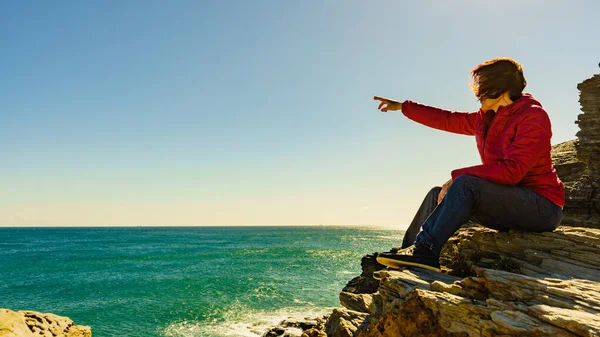 Tourist woman on sea cliffs in Spain Stock Photo