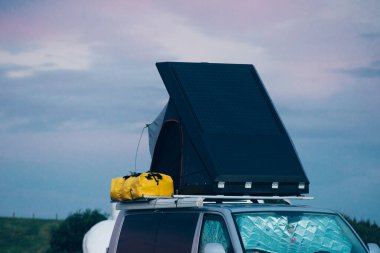 Yol kenarında çatıda çadıra sahip Camper Van