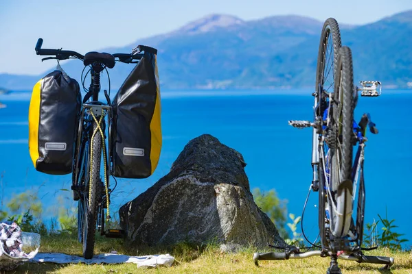 Bike repair. Mountain bicycle with saddlebag against nature, mountains fjord landscape in Norway