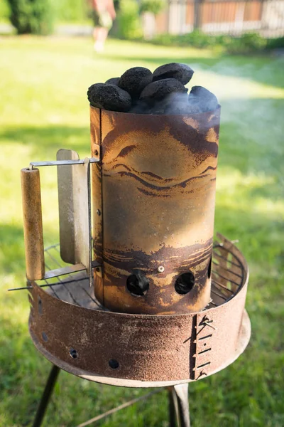 Grill garden party with sausages and meat on hot briquette