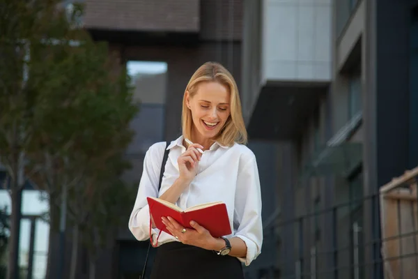 Happy woman with notebook