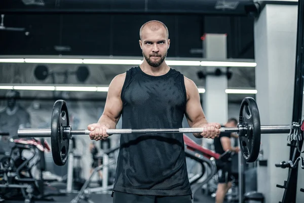 Homme musclé travaillant dans la salle de gym faire des exercices avec haltère au biceps, mâle fort — Photo