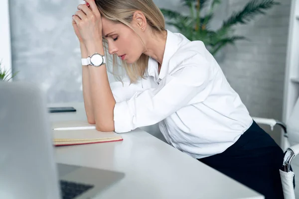 Young frustrated exhausted woman laid her head down on the table sit work at white desk with contemporary pc laptop Achievement business career concept.