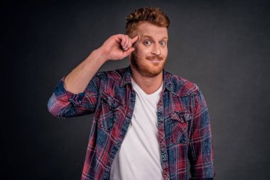 Kızıl saçlı adam, son zamanlarda delirmiş olan ve aptalca kararlar veren garip bir arkadaşı tartışıyor. Olgun Avrupalı bir adamın portresi şakakta yuvarlanıyor ve kendini aptal yerine koyan biriyle alay ediyor..