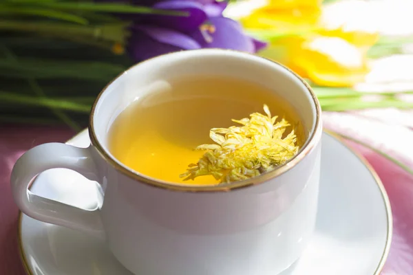 green flower tea with yellow chrysanthemum