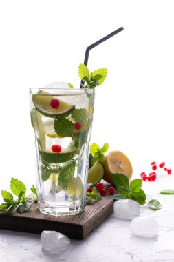 Ev mojito kokteyl limon, limon, nane yaprağı, buz ve kırmızı kuş üzümü ile yaptı. Yaz içki kavramı. 