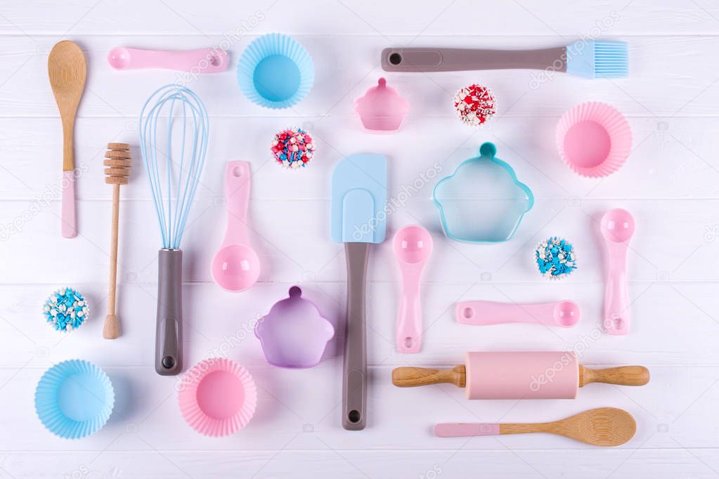 Baking and cooking concept. Pattern made of cookie cutters, whisk, roller pin and kitchen bake tools for making sweets. White  background. Top view of a holiday baking still life