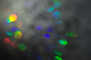 Renkli daireler ışık arka plan. Tatil doku. Gri zemin, defocused çok renkli ışık noktalar glitter