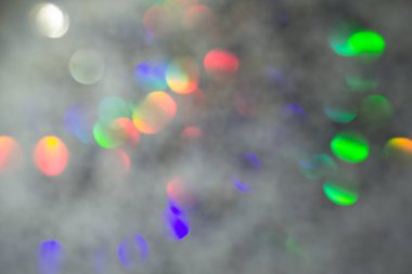 Renkli daireler ışık arka plan. Tatil doku. Gri zemin, defocused çok renkli ışık noktalar glitter