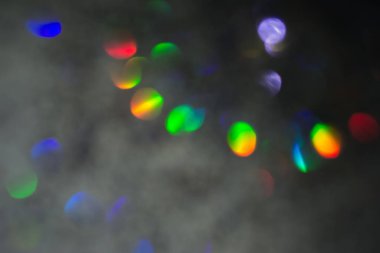 Renkli daireler ışık arka plan. Tatil doku. Gri zemin, defocused çok renkli ışık noktalar glitter