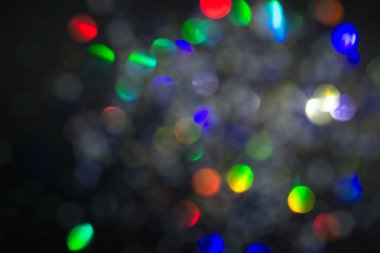 Renkli daireler ışık arka plan. Tatil doku. Gri zemin, defocused çok renkli ışık noktalar glitter