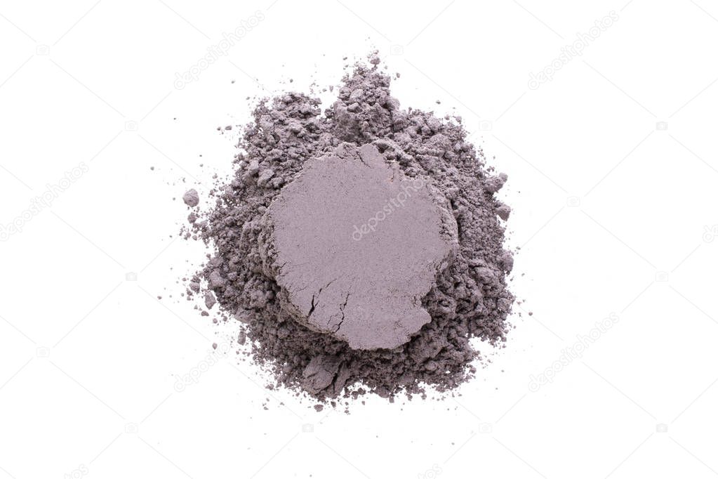Pile of yellow  black cosmetic clay isolated on white background