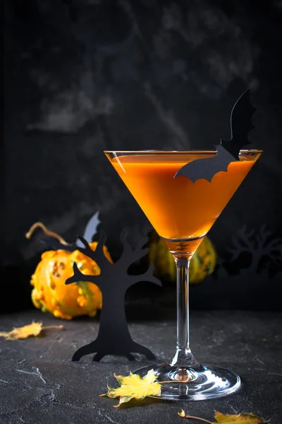 Orange pumpkin, Halloween drink for party and holiday decorations over black background with copy space