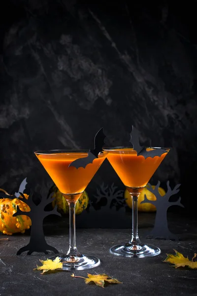 Orange pumpkin, Halloween drink for party and holiday decorations over black background with copy space