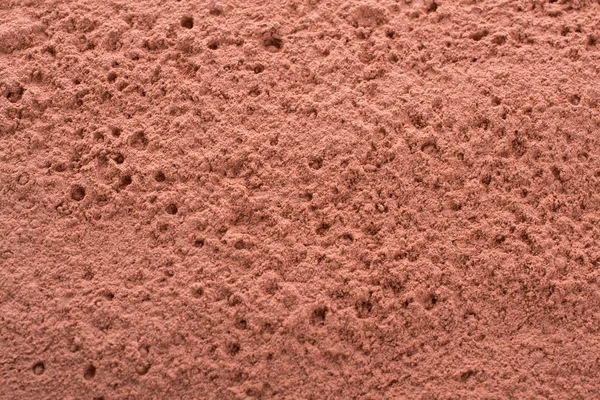 Cosmetic  red clay texture, background. Natural mask, dry clay for the face and body.