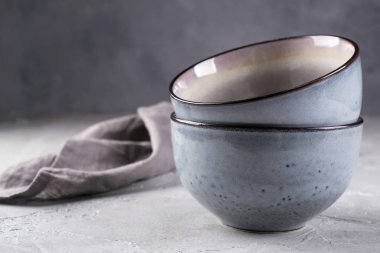 Rustik tarzı yığını elişi eski püskü gri duvar karşı nötr tonları sokup. Basit sofra