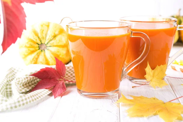 Mevsim sonbahar Şükran kavramı. Kabak taze meyve suyu içmek kokteyl sonbaharda akçaağaç beyaz bir masada bırakır. Kopya alanı 