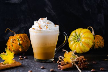 Kabak spice latte krem şanti üstte ve mevsim sonbahar baharat ve Sonbahar dekorasyonu ile fincan. Geleneksel kahve içmeye sonbahar ya da kış tatilleri, kopya alanı.
