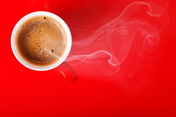 Fragrant coffee on a red background for your advertising. Smoke from hot coffee.