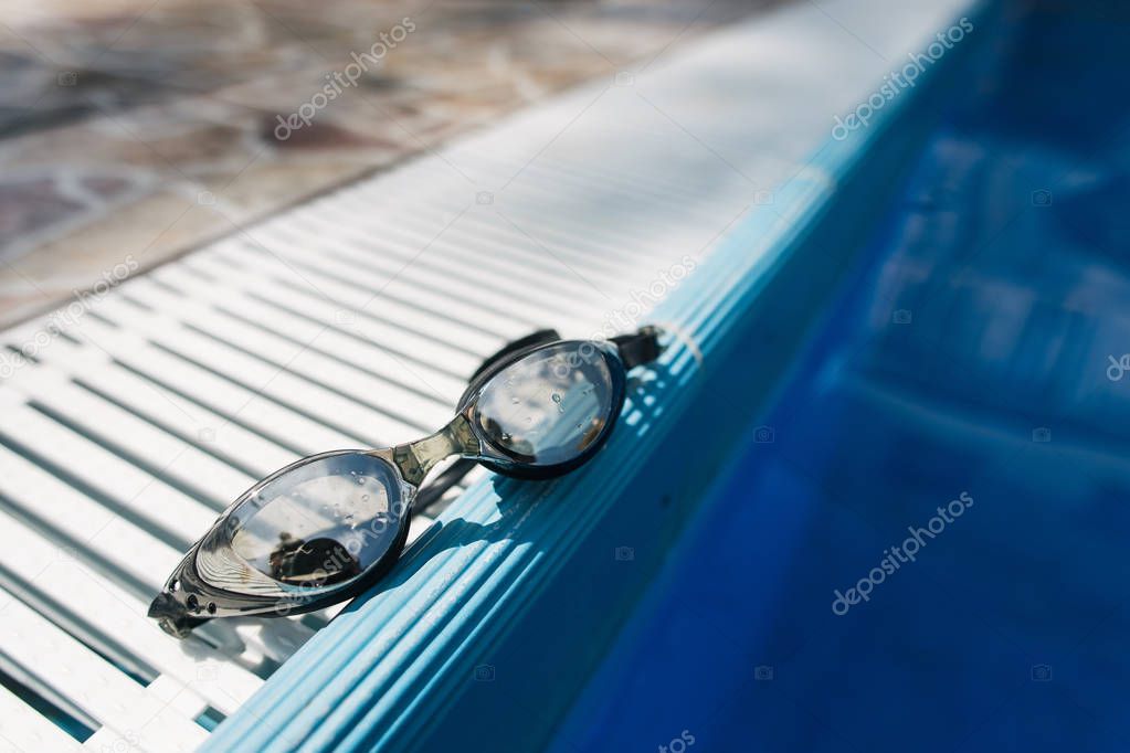 swimming goggles lie by the pool