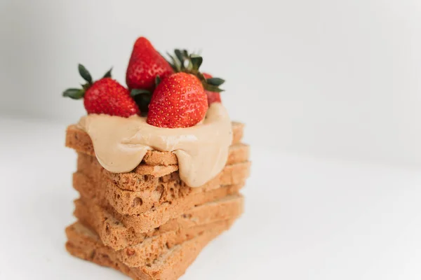 toast bread with peanut paste and strawberries