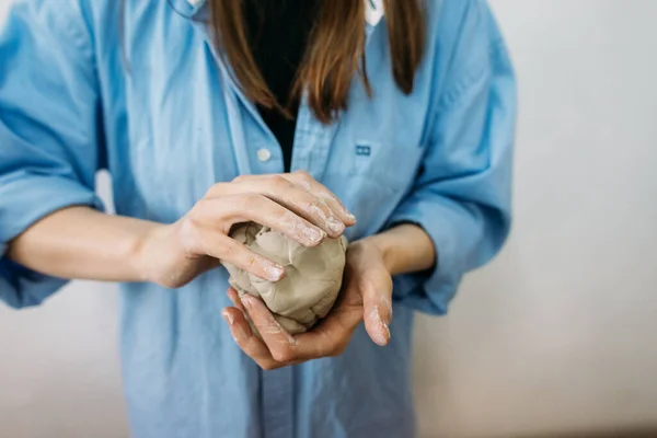 young woman, potter, makes utensils with their own hands in their own workshop