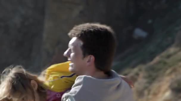 Happy parents and the daughter walk on the coast in the sunny day — Stock Video