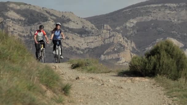 Молодая пара на горных велосипедах — стоковое видео