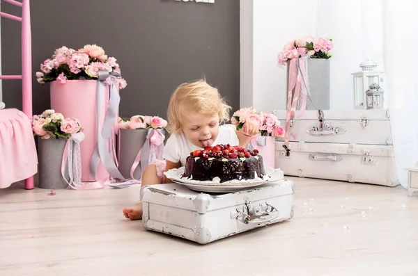 Happy Little Blonde Girl Licks His Birthday Chocolate Berry Cake — Stock Photo, Image
