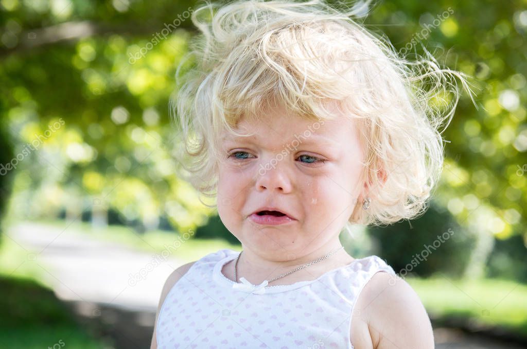 little girl child blonde bitterly cries. negative emotions