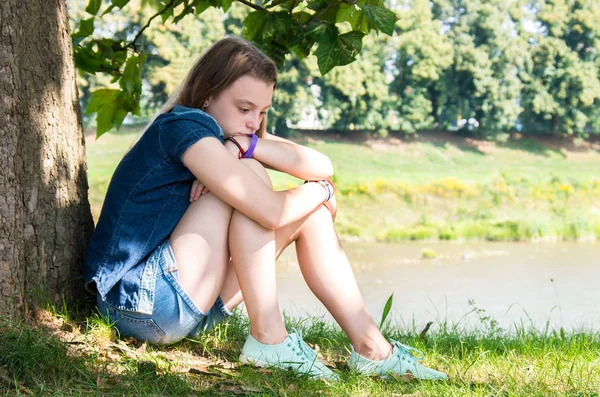 Pensive Sad Girl Teen Sitting Grass Leaning Tree Stock Image