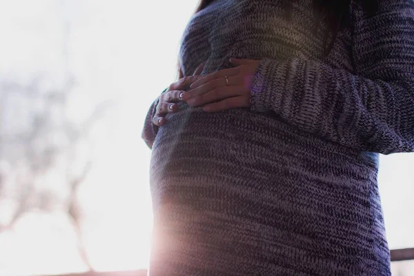 Pregnant Woman with hands on stomach