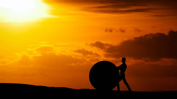 Man Pushing Rock Uphill