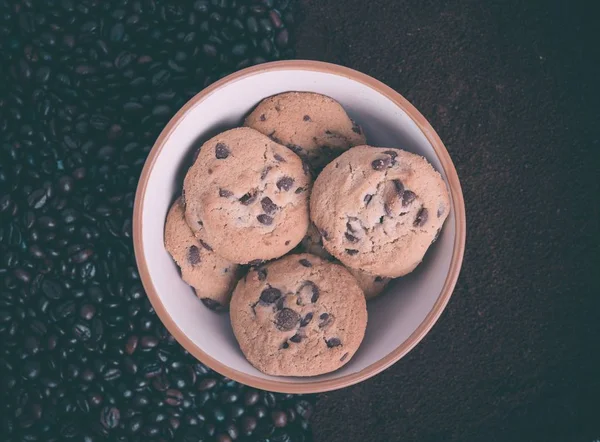 Bowl of Cookies with chocolate on coffee beans background