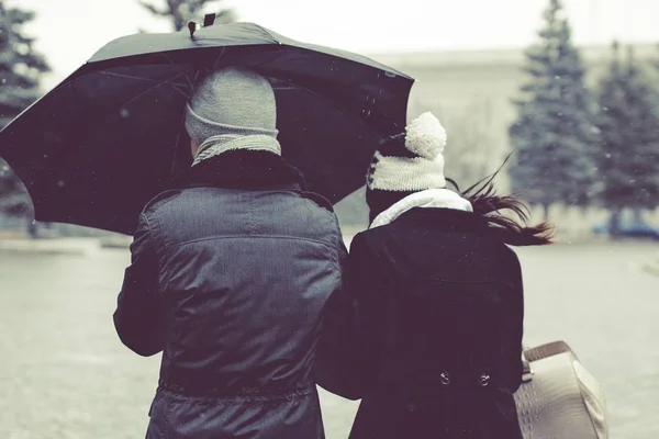 Sharing umbrella with partner