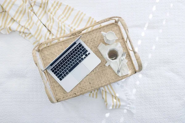 close up of Laptop on Table with a cup of tea