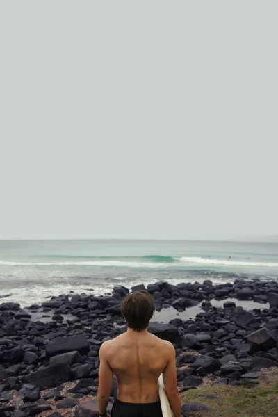 Surfer on rocks  at the day time