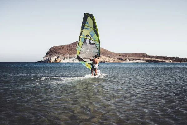 man Windsurfing on the sea  at the daytime