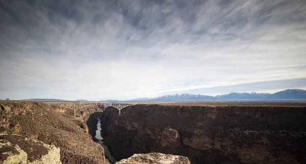 bridge between rocky mountains   at day time