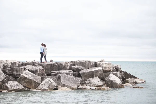 Couple standing on the rocks  at the day time