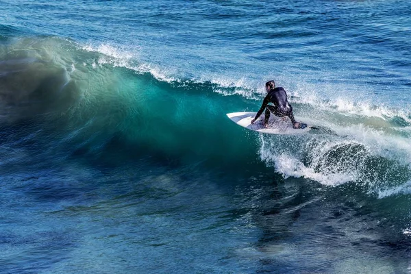 Surfer riding wave at the day time