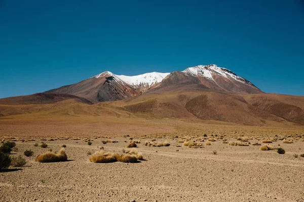 Desert with sand and mountains top of ice